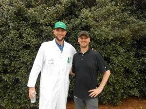 Hal Lanier with Cody Jones in a Masters caddie uniform at The Masters, 2022.